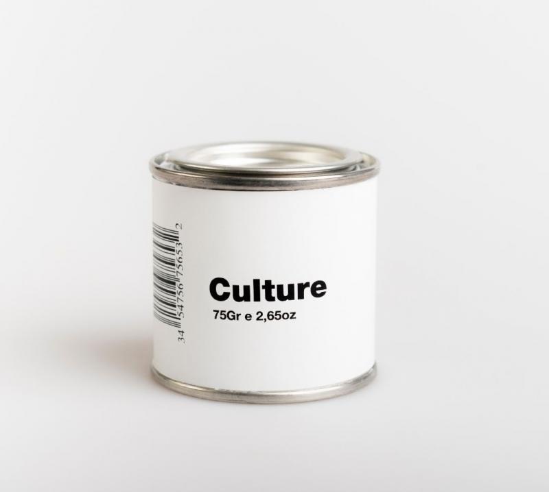 Pot of white paint with the label that says Culture