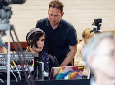 A young person being trained by a technician