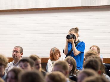 A young person holding a camera