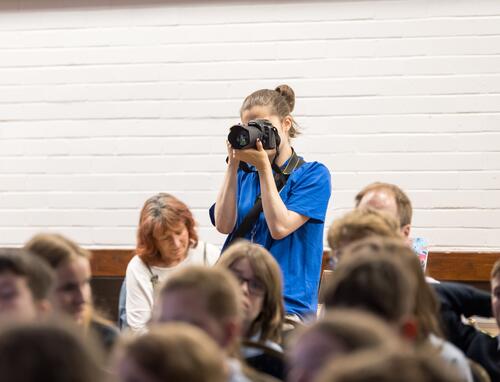 Young intern taking photographs