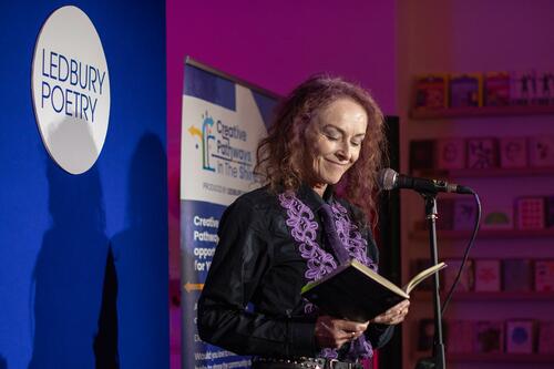 Rosie garland smiling and holding a book