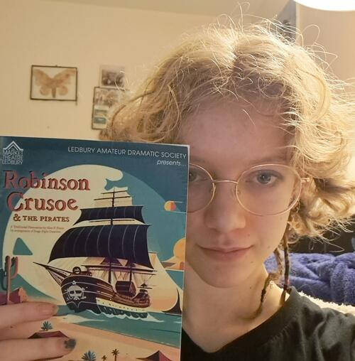 Alice Drury holding a programme of Robinson Crusoe