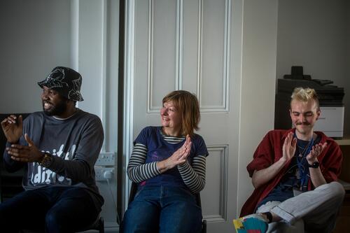 Anyone based in Herefordshire, aged 16 and up Three volunteers at Ledbury Poetry clapping and smiling