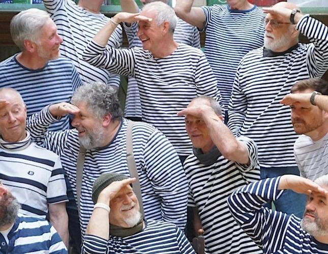 A group of men in striped shirts posing for a photo.